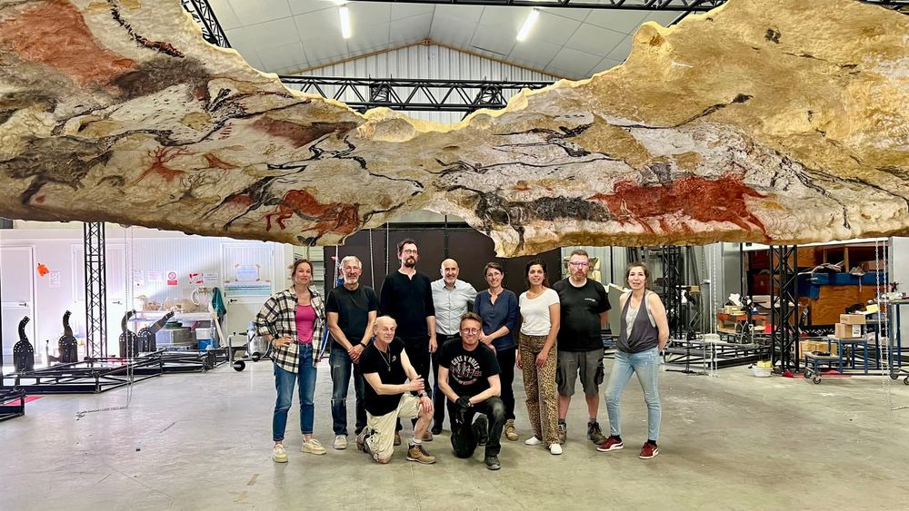 The team gathered beneath the Hall of the Bulls ceiling, at the workshop